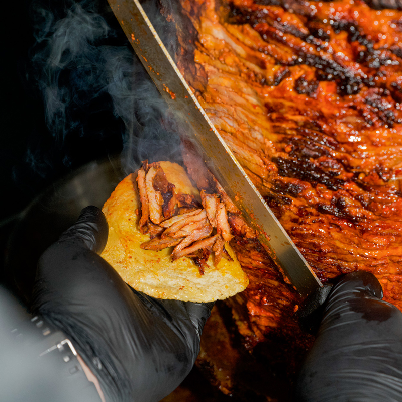 someone cutting pork kabob